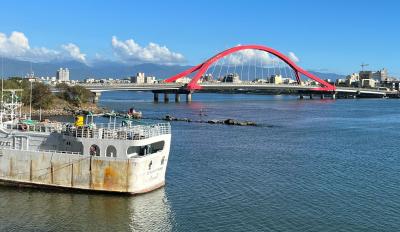 Taiwanese Fishing Vessel Photo of Taiwan fishing vessel docked at Donggang Harbor with red arched bridge in background