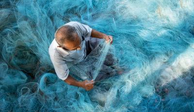 Thai man making fishing net Thai man making fishing net - photo by Shutterstock